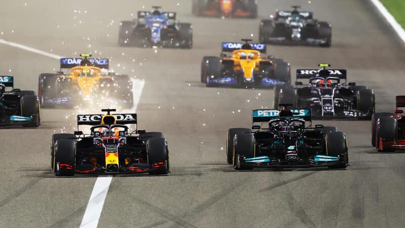 Red Bull of Max Verstappen alongside Mercedes of Lewis Hamilton at the start of the 2021 F1 Bahrain Grand Prix