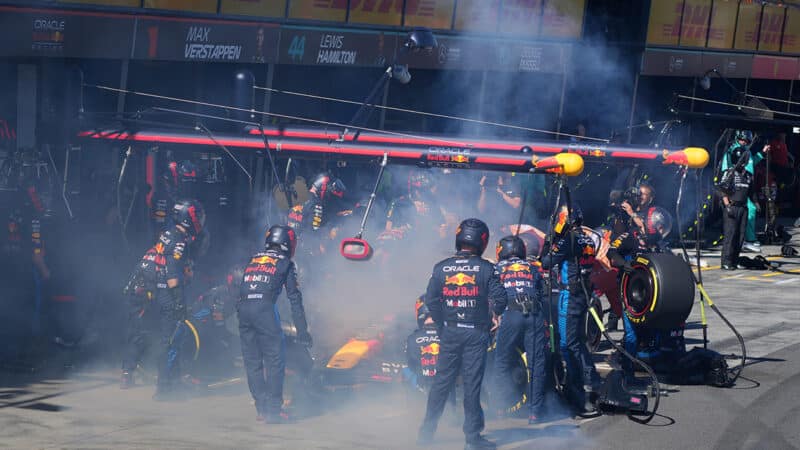 Smoke surrounds Red Bull F1 car of MAx Verstappen in the pits at 2024 Australian Grand Prix