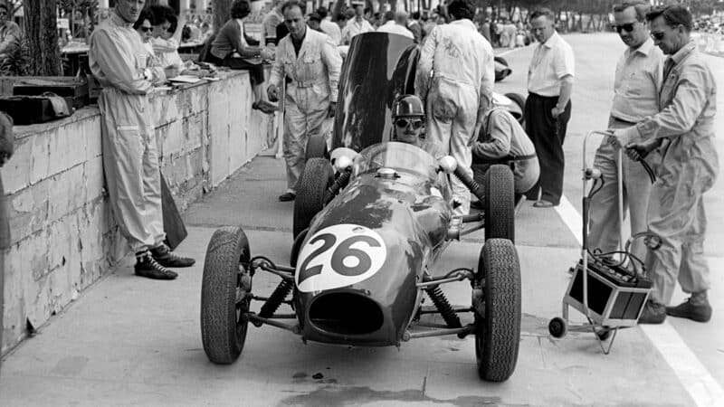 Graham Hill in 353, Monaco, 1958, with Chapman on right (in shades