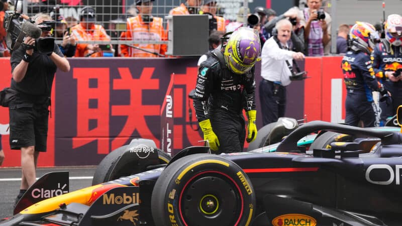 Lewis Hamilton examines the Red Bull of Max Verstappen