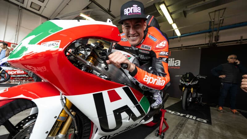 Aleix Espargaro on Aprilia in MotoGP pit garage