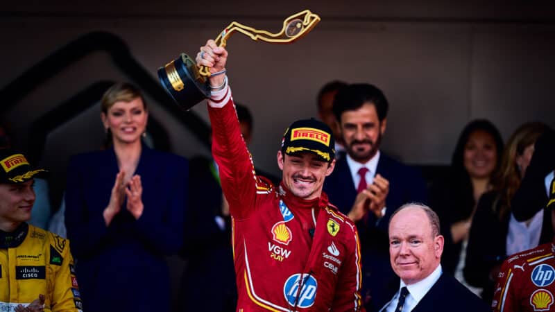 Charles Leclerc raises Monaco GP trophy after winning in 2024