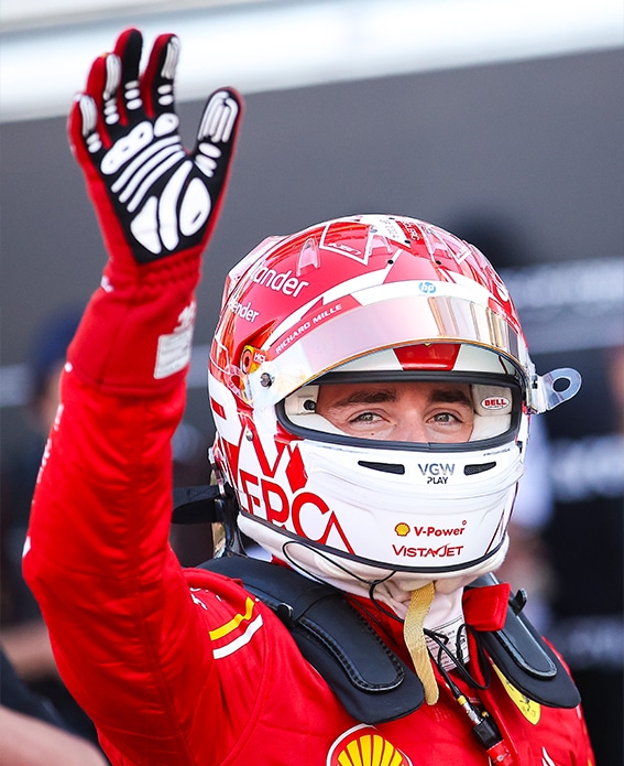 Charles Leclerc raises his hand after securing pole position in 2024 F1 Monaco GP