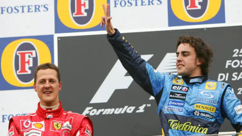 Fernando Alonso celebrates 2005 F1 San Marino GP on the podium with Michael Schumacher