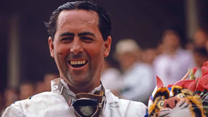 Jack Brabham celebrates victory holding soft toy tiger at the 1966 European GP in Reims