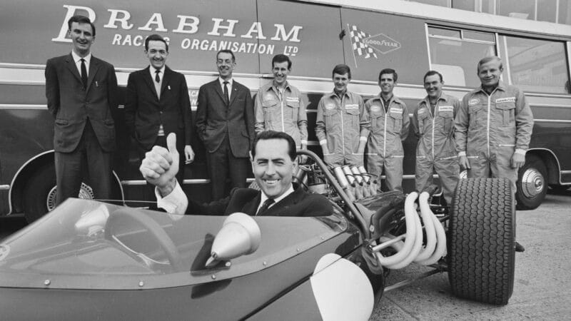 Jack Brabham in 1966 F1 car with team members