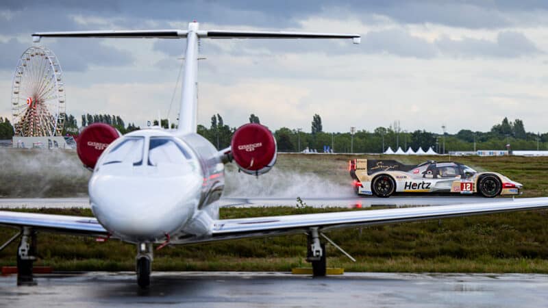 No12 Jota Porsche drives past aeroplane at Le Mans shakedown