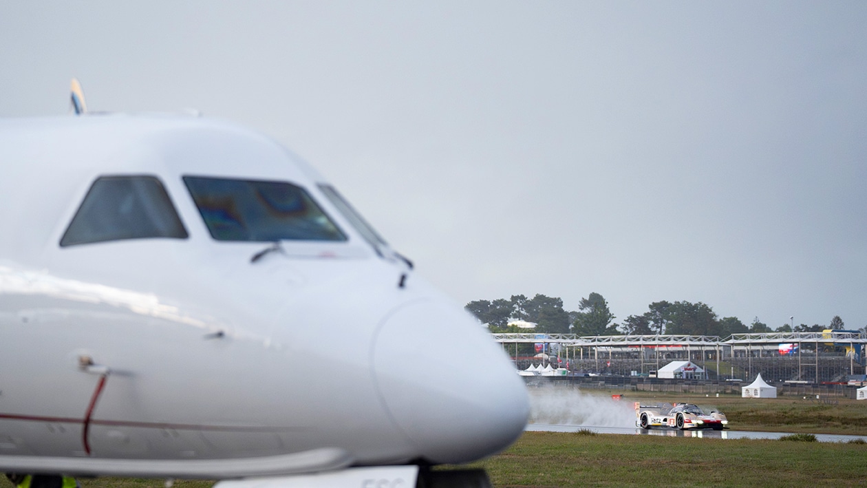 No12 Jota at 2024 Le Mans shakedown with aeroplane in foreground