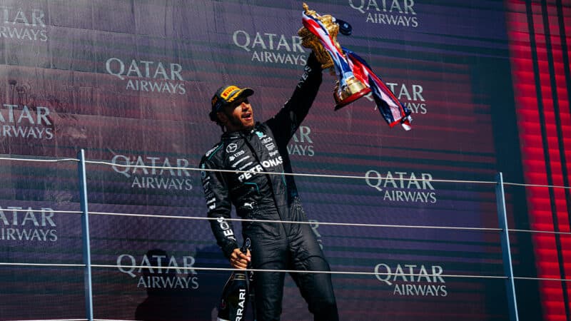 Lewis Hamilton raises British GP trophy after winning 2024 F1 race