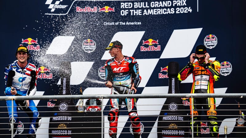 Moto2 riders spray champagne on the podium at Circuit of the Americas