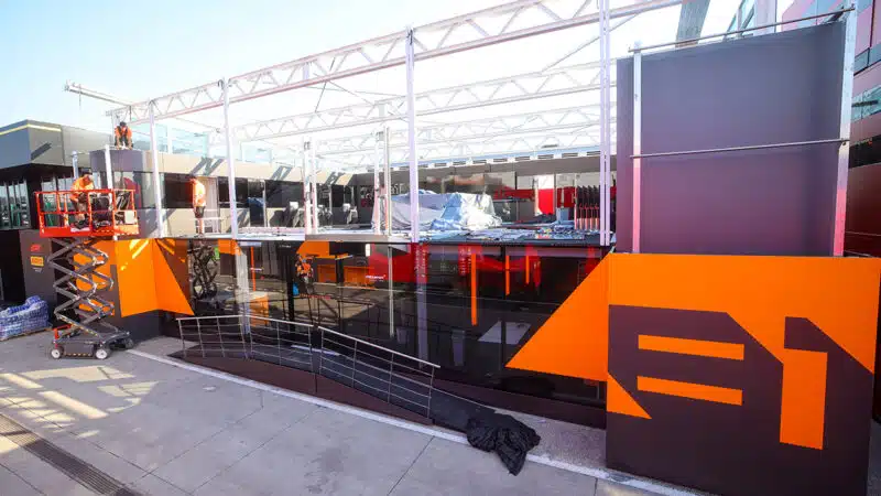 Workers repair McLaren F1 hospitality unit after storm damage at 2024 Hungarian Grand Prix