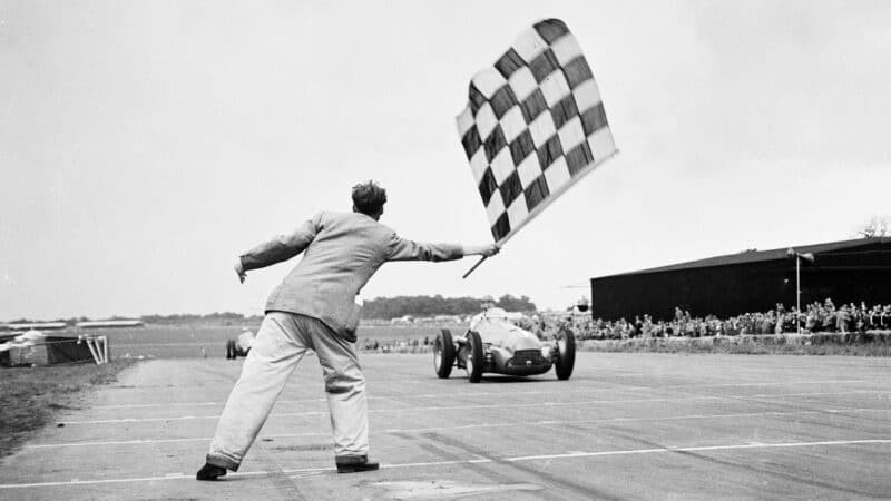 The first of his kind: Farina takes the chequered flag at Silverstone in 1950 to win the inaugural world championship grand prix for Alfa Romeo