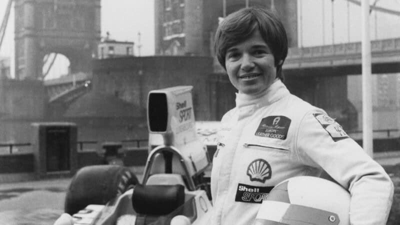 A promo shot in front of Tower Bridge to advertise the 1974 Race of Champions at Brands Hatch. Lombardi stands with her Lola T330-Chevrolet F5000