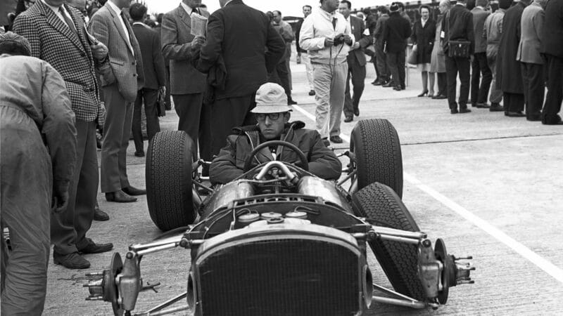 Forghieri completing checks on a 1512 at Silverstone, 1965