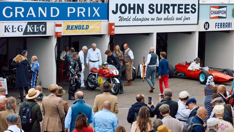 2024 Goodwood Revival crowd looks at John Surtees race winning motorbike and grand prix car