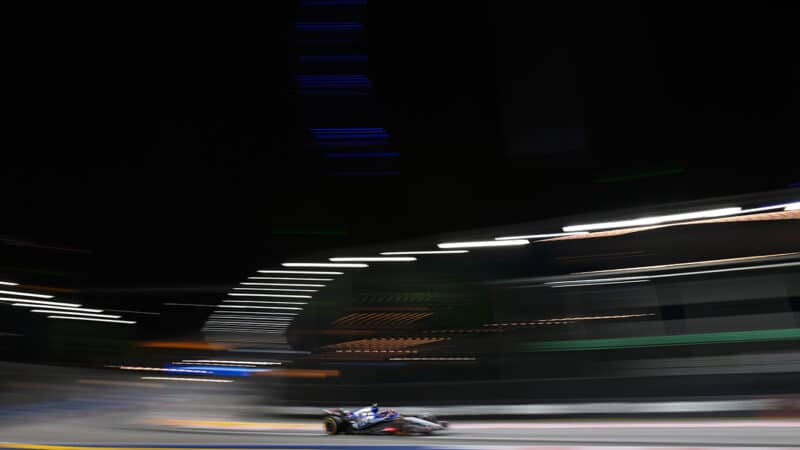 Blurred RB F1 car of Daniel Ricciardo in the 2024 F1 Singapore Grand Prix