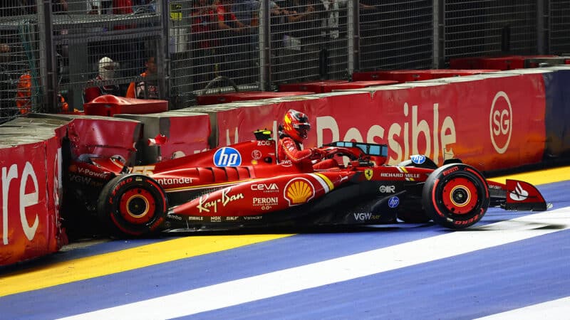 Carlos Sainz steps out of his crashed Ferrari F1 car in 2024 Singapore Grand Prix qualifying