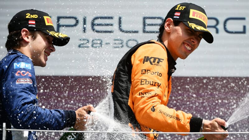 Franco Colapinto and Gabriel Bortoleto spray champagne on Formula 2 podium