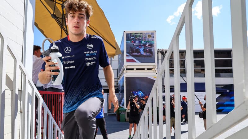 Franco Colapinto climbs stairs in F1 paddock