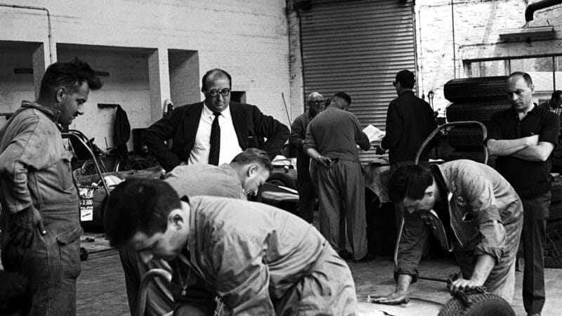 Chiti watches Ferrari mechanics work on the 156s. He oversaw every aspect of his cars from drawing board to pitlane, especially once he moved to Alfa and Autodelta