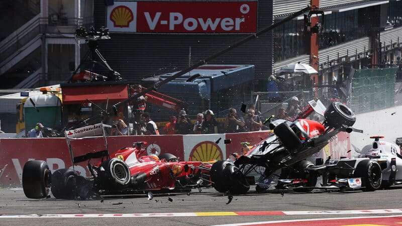 McLaren F1 car of Lewis Hamilton is lifted in the air during a crash at the start of the 2012 Belgian Grand Prix