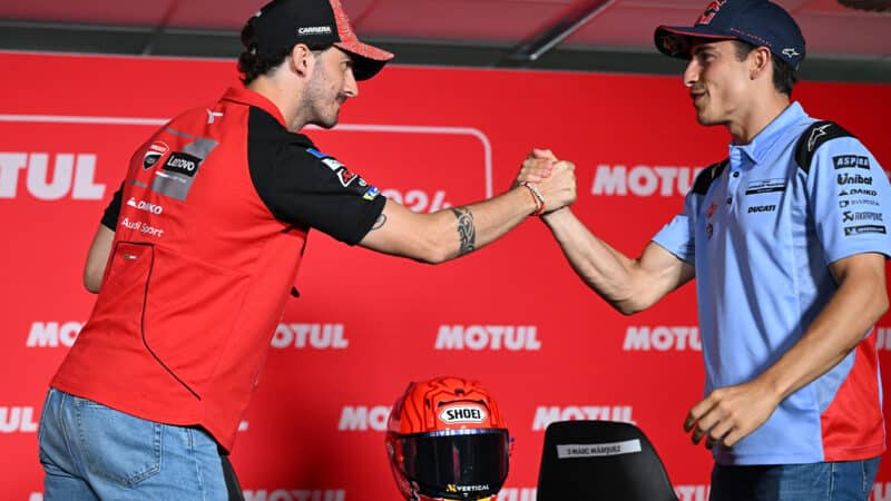 Pecco Bagnaia shakes hands with Marc Marquez