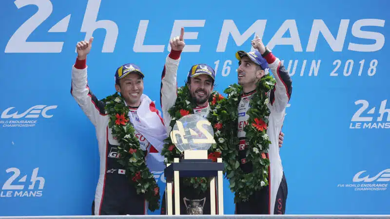 Fernando Alonso with Kazuki Nakajima and Sebastien Buemi on the podium after winning 2018 Le Mans 24 Hours