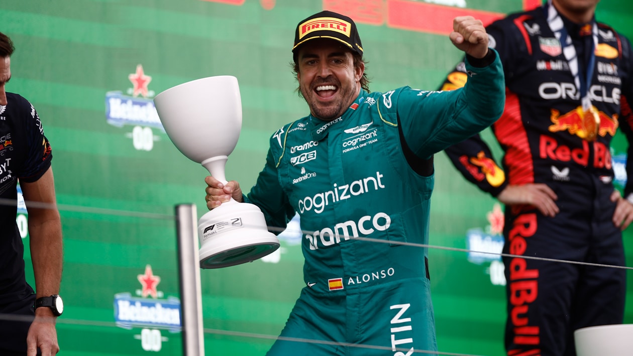 Fernando Alonso with second place trophy celebrates on the podium at the 2023 F1 Dutch Grand Prix