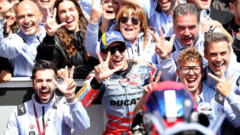 Marc Marquez holds up three fingers with his crew after winning the 2024 MotoGP Australian GP