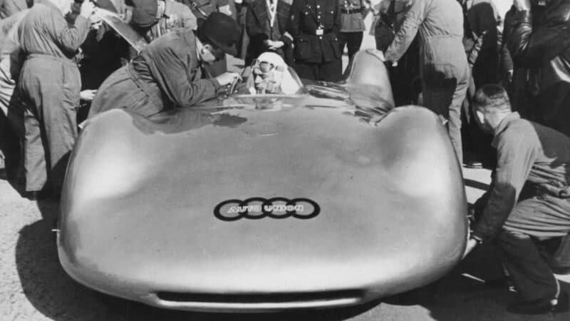 Porsche leans in to speak to Rosemeyer