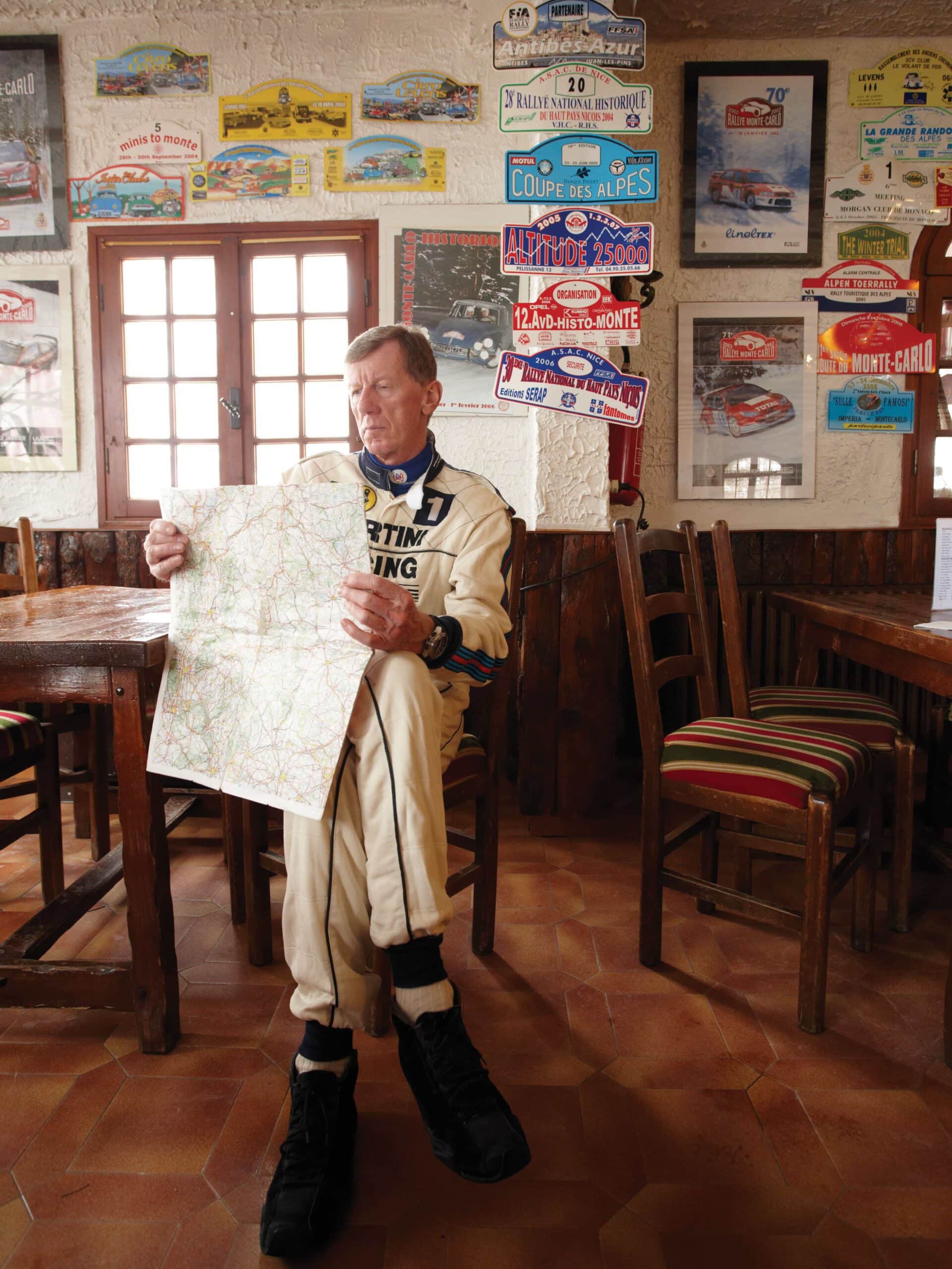 Walter Röhrl sitting and reading map