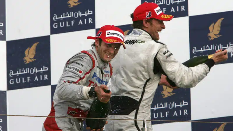 Jarno Trulli and Jenson Button spray champagne on the podium after the 2009 F1 Bahrain Grand Prix