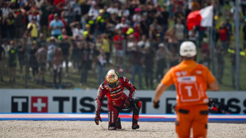 Pecco Baganaia getting up after crash into gravel trap