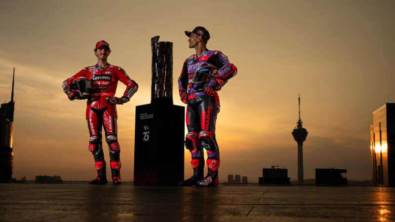 Pecco Bagnaia and Jorge MArtin either side of MotoGP trophy