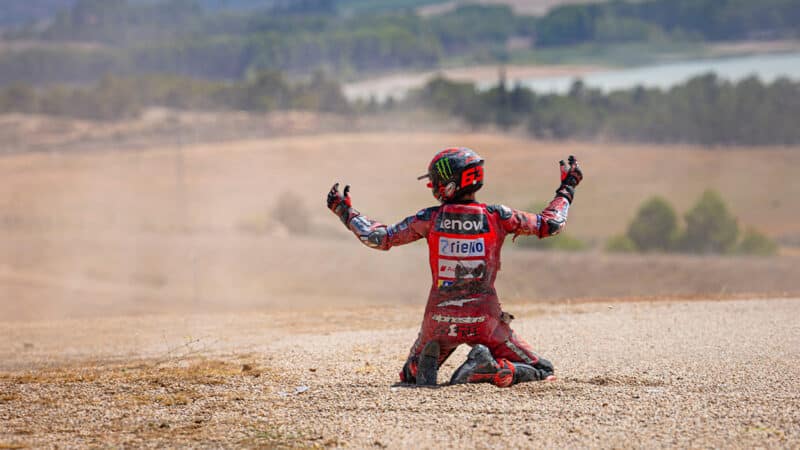 Pecco Bagnaia holds his hands up after crashing in 2024 MotoGP Aragon GP