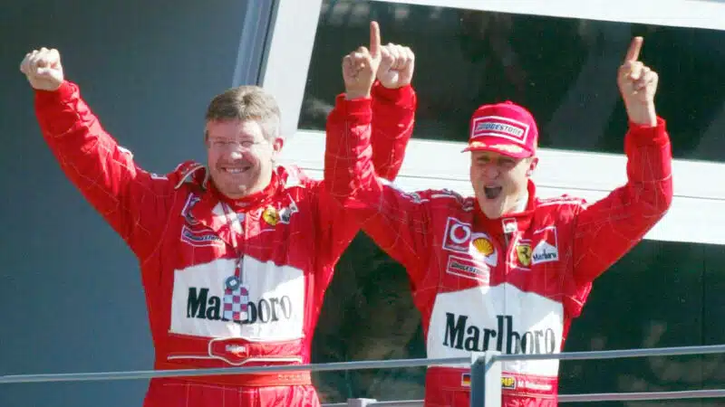 Ross Brawn with Michael Schumacher on the podium after the 2003 Italian Grand Prix