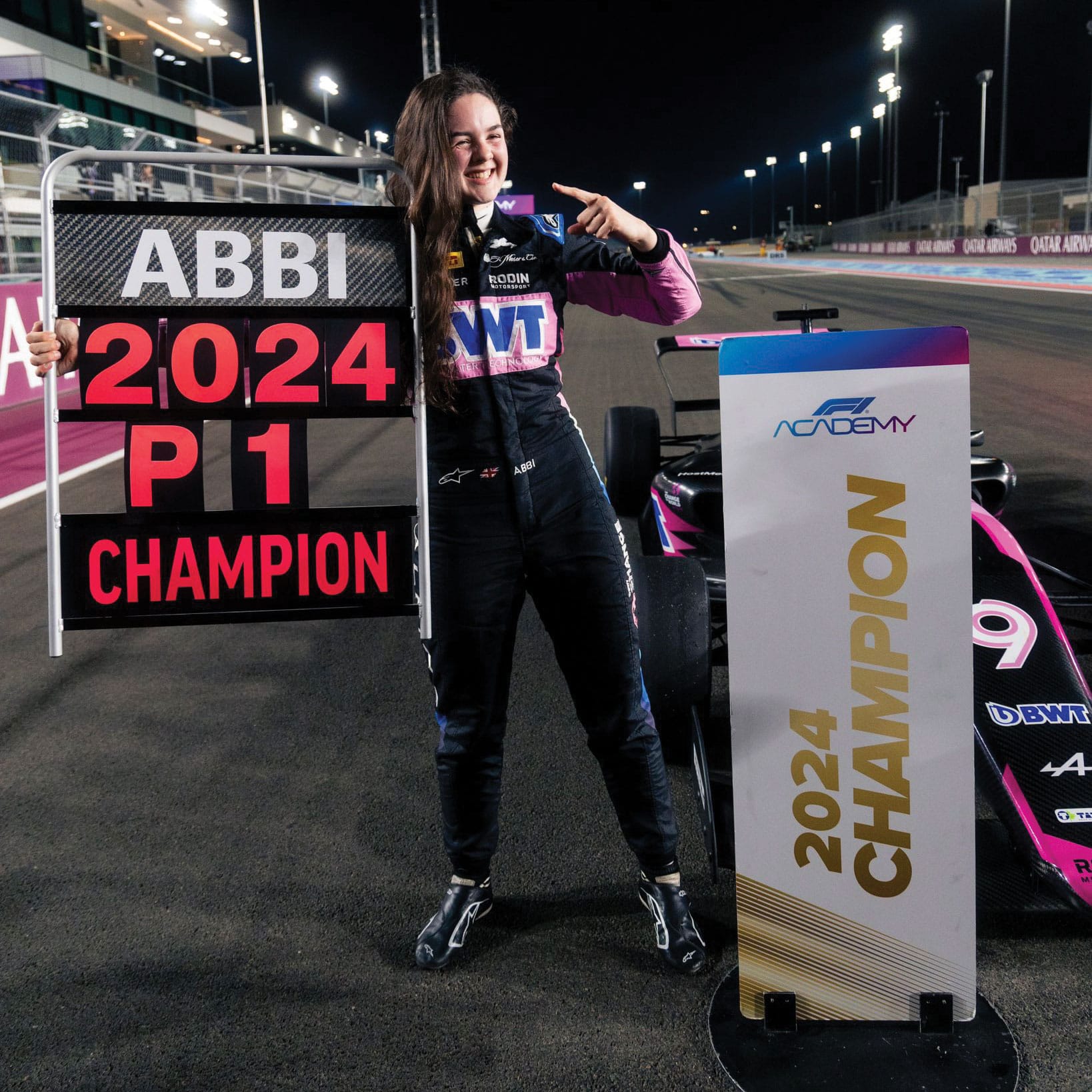 Abbi Pulling holding champion sign