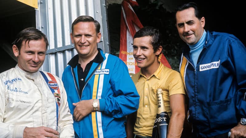 Bruce McLaren with Jacky Ickx and Colin Chapman after winning 1969 F1 German Grand Prix