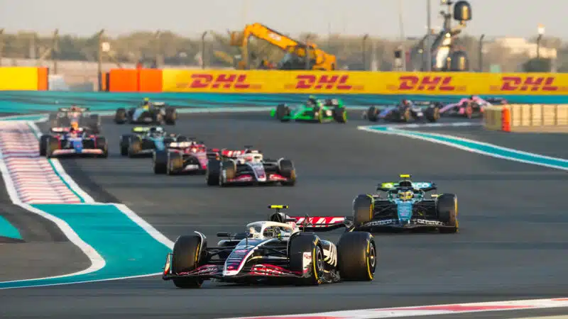 Nico Hulkenberg ahead of a line of F1 cars in the 2024 F1 Abu Dhabi Grand Prix