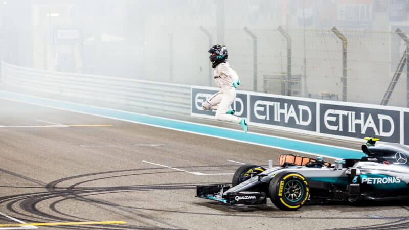 Nico Rosberg leaps from his Mercedes F1 car after winning the 2016 F1 world championship