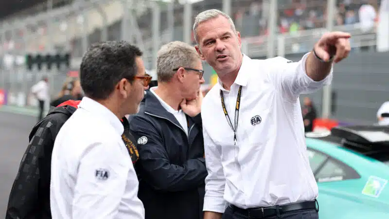 Niels Wittich next to Aston Martin safety car on the F1 grid