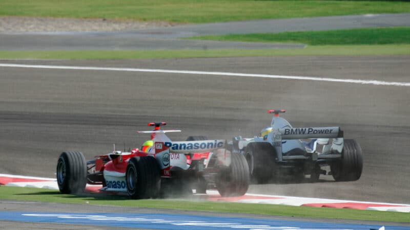 Ralf Schumacher runs off track as he fights with the Williams of Nico Rosberg in the 2006 F1 Bahrain Grand Prix