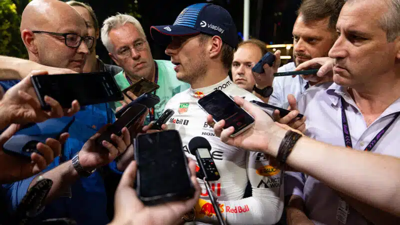 Reporters interview Max Verstappen in the paddock at the 2024 F1 Singapore Grand Prix