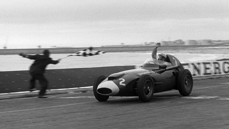 Stirling Moss wins raises his arm as he wins the 1958 Portuguese Grand Prix for Vanwall