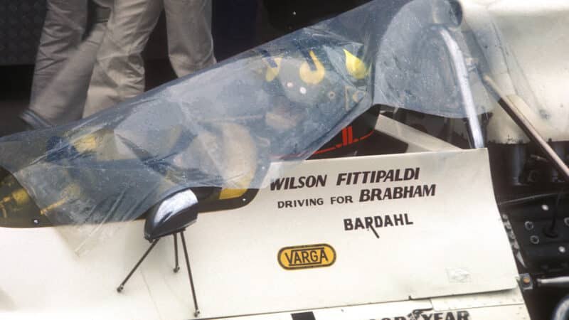 Wilson Fittipaldi underneath rain cover in Brabham F1 car