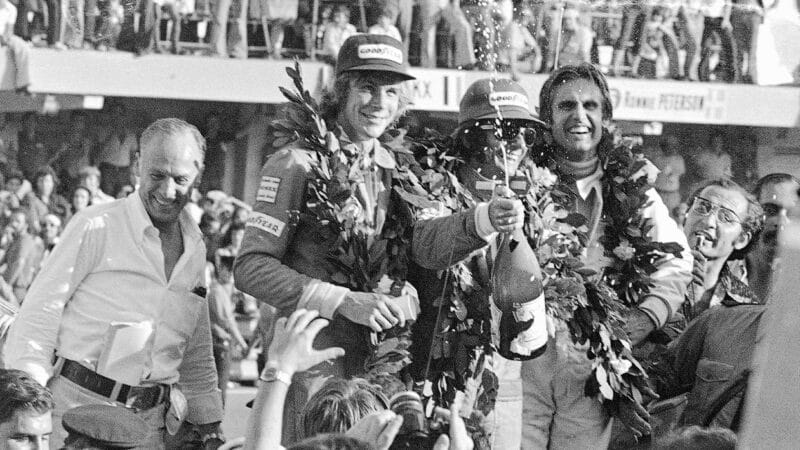 Emerson Fittipaldi with James Hunt and Carlos Reutemann on the podium after the 1975 F1 Argentine Grand Prix