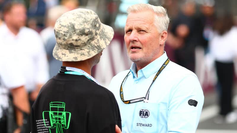 Johnny Herbert on F1 grid with FIA Steward shirt