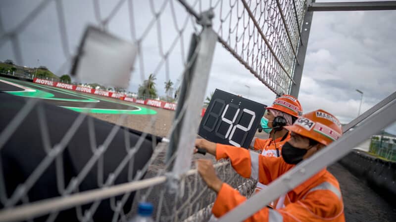 MotoGP marshals wave black flag