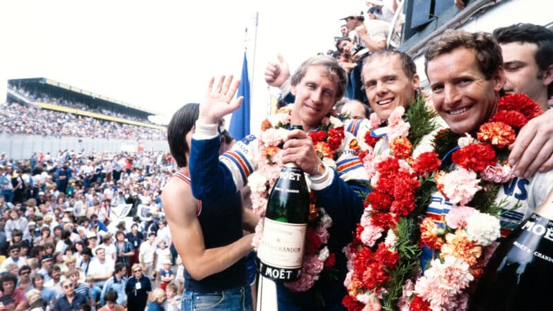 Vern Schuppan with Hurley Haywood and Al Holbert on the podium after winning the 1983 Le Mans 24 Hours