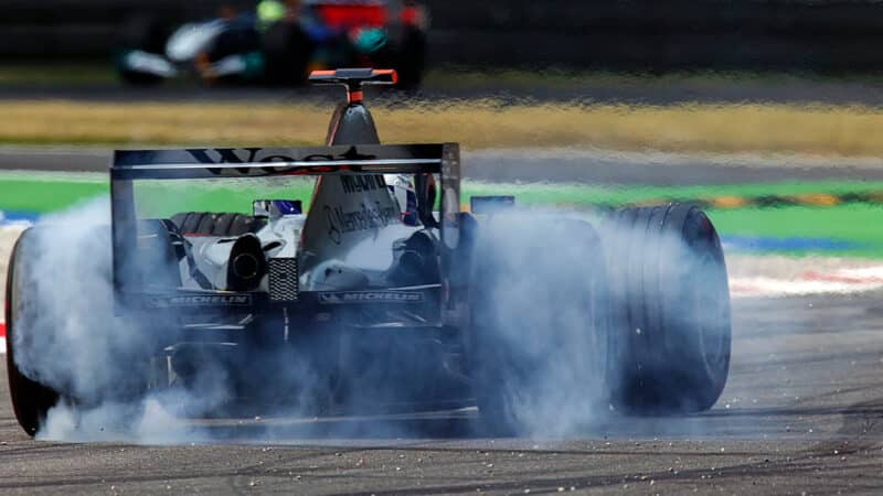 David Coulthard smokes the rear tyres of his V10 McLaren in 2004